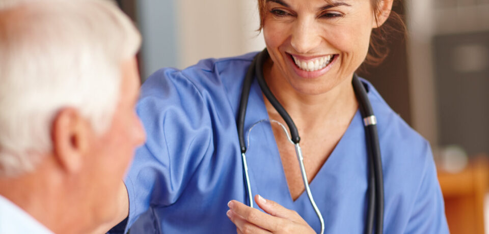 Cropped shot of a female nurse checking on her senior patient