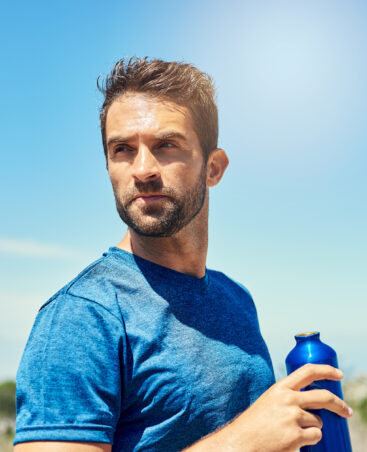 Cropped shot of a young man taking a break while out for a run.