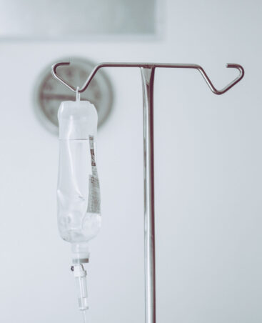IV bag hanging on a metal pole in the hospital room